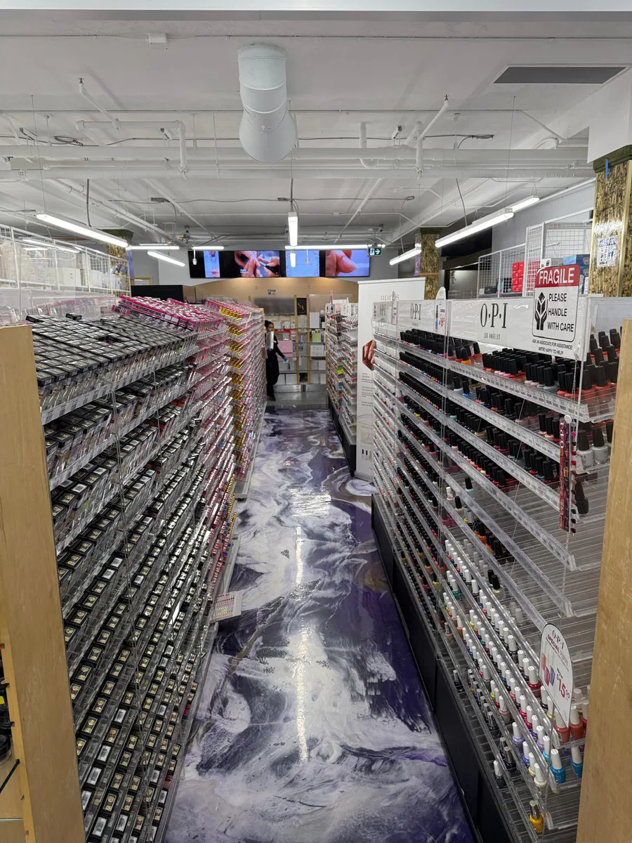 Retail aisle over the purple, black, and white custom epoxy floor designed and completed by Kaveh.